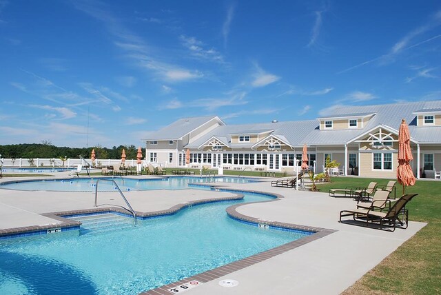 view of swimming pool featuring a lawn and a water slide