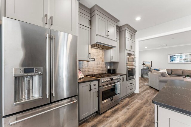 bar featuring dishwasher, dark hardwood / wood-style flooring, sink, and beverage cooler