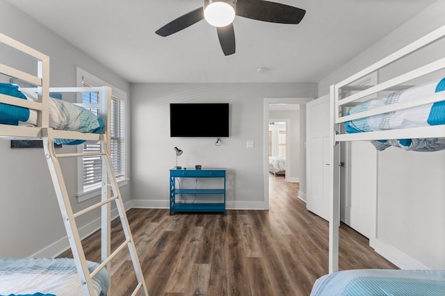 bedroom featuring multiple windows, ceiling fan, and dark wood-type flooring