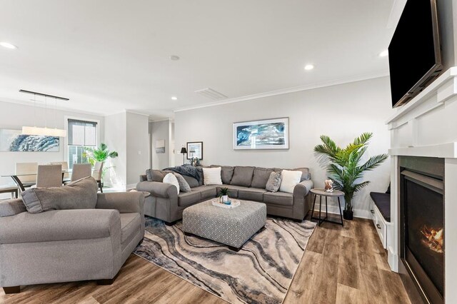 living room with ornamental molding and dark wood-type flooring