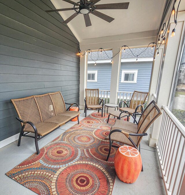 sunroom / solarium with ceiling fan and lofted ceiling