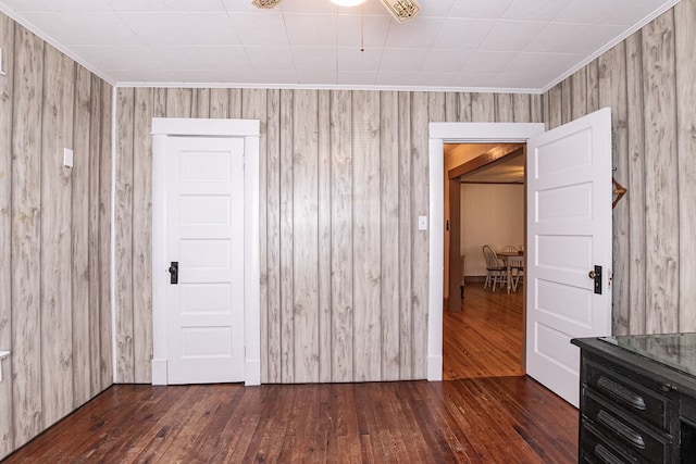 24103 Adelaide St, Parksley, VA 23421 - empty room featuring hardwood / wood-style floors, wooden walls, ceiling fan, and crown molding
