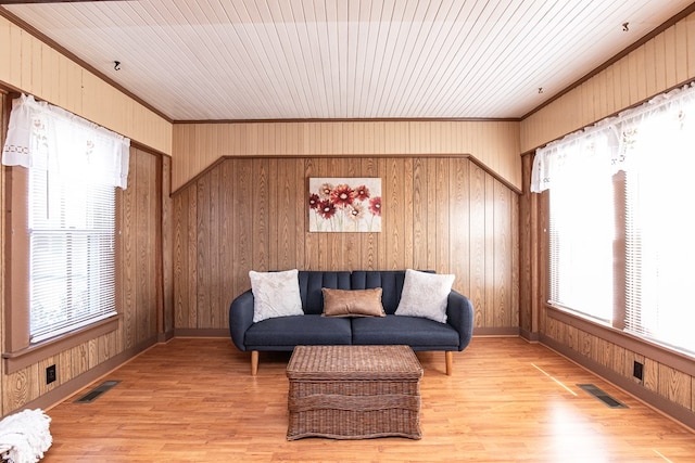 24103 Adelaide St, Parksley, VA 23421 - living area featuring ornamental molding, light wood-type flooring, and wood walls