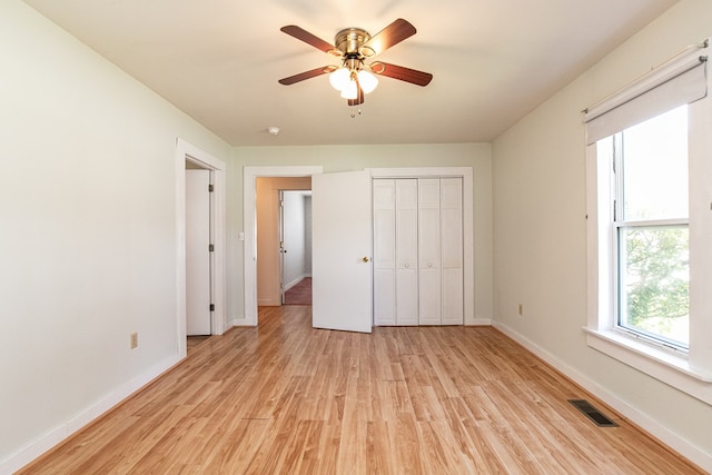 24103 Adelaide St, Parksley, VA 23421 - unfurnished bedroom with light wood-style flooring, a closet, and a ceiling fan