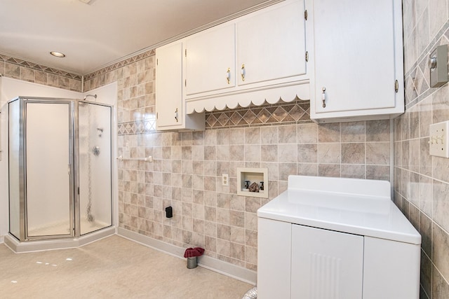 24103 Adelaide St, Parksley, VA 23421 - washroom featuring tile walls, washer / dryer, and cabinet space