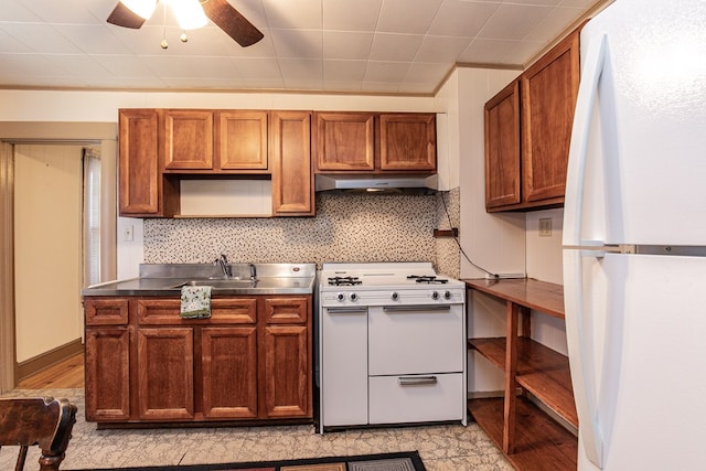 24103 Adelaide St, Parksley, VA 23421 - kitchen with white appliances, under cabinet range hood, brown cabinetry, stainless steel countertops, and ceiling fan