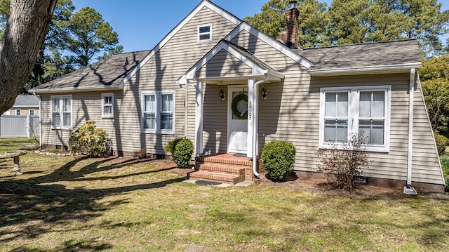 24103 Adelaide St, Parksley, VA 23421 - view of front of house featuring a chimney, a front lawn, and a shingled roof