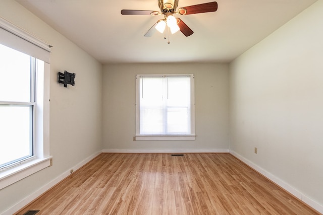 24103 Adelaide St, Parksley, VA 23421 - empty room featuring light wood-style flooring, plenty of natural light, and a ceiling fan