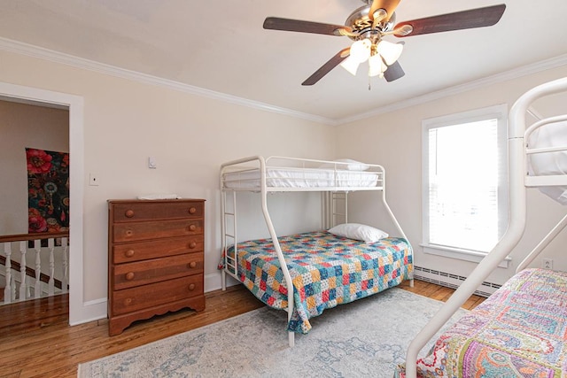 521 Madison Ave, Cape Charles, VA 23310 - bedroom featuring a baseboard heating unit, baseboards, ceiling fan, crown molding, and wood finished floors