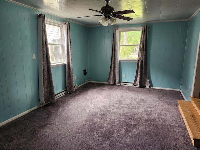 4068 Ridge Rd, Chincoteague, VA 23336 - carpeted spare room with a ceiling fan, crown molding, wooden walls, baseboards, and a baseboard heating unit