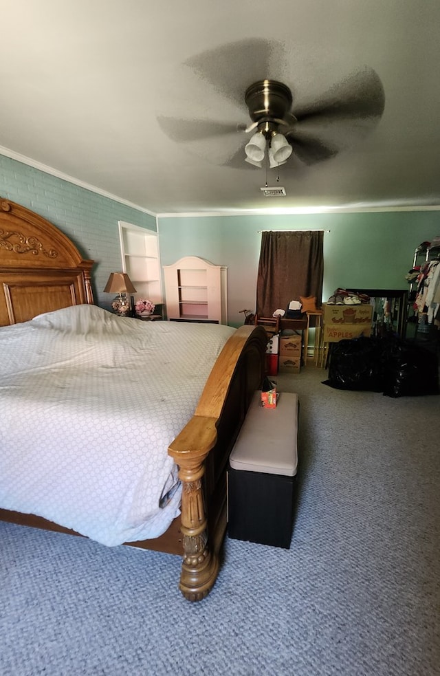 carpeted bedroom featuring ceiling fan, ornamental molding, and brick wall