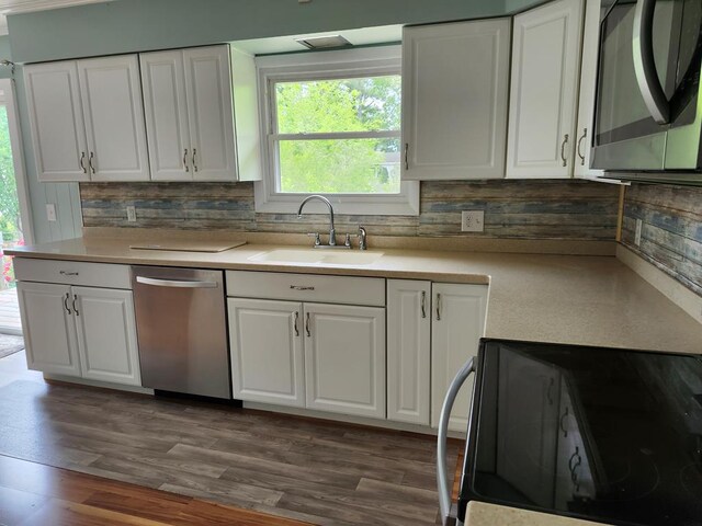 4068 Ridge Rd, Chincoteague, VA 23336 - kitchen with a sink, stainless steel appliances, backsplash, and white cabinets