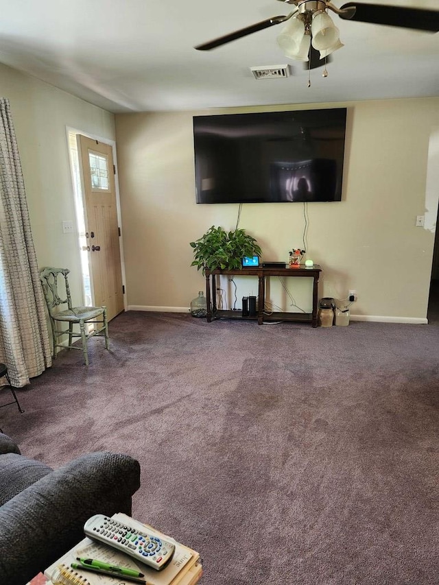 carpeted living room featuring ceiling fan