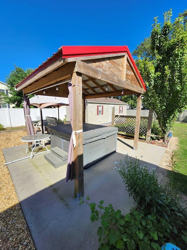 view of patio / terrace featuring a gazebo and a hot tub