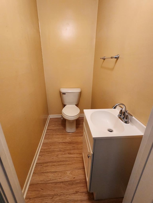 4068 Ridge Rd, Chincoteague, VA 23336 - bathroom featuring wood finished floors, vanity, toilet, and baseboards