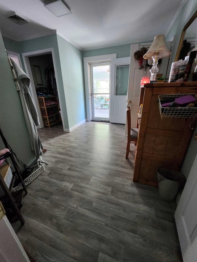 hall with dark hardwood / wood-style floors and ornamental molding