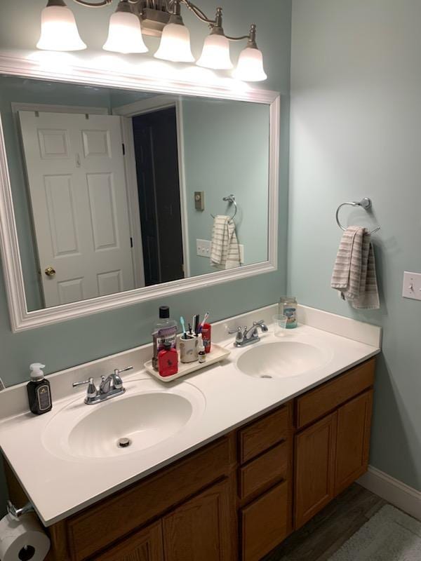 bathroom with hardwood / wood-style flooring and vanity