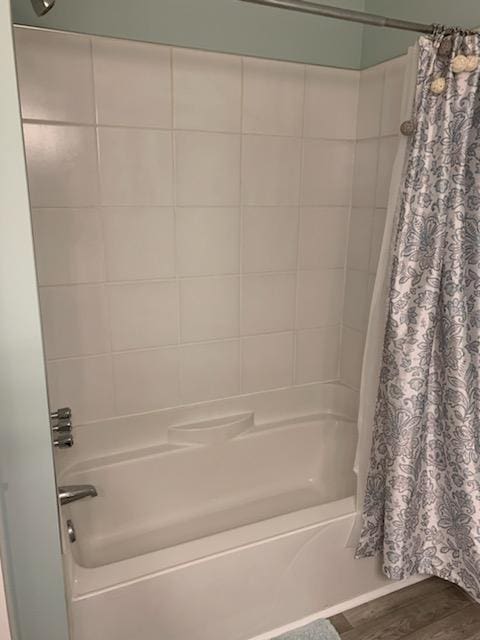 bathroom with shower / bath combo with shower curtain and hardwood / wood-style floors