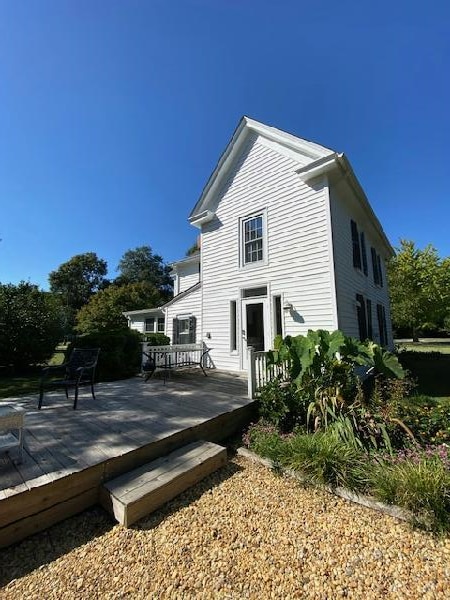 rear view of property with a wooden deck