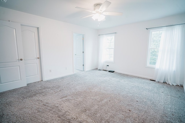 unfurnished bedroom featuring baseboards, ceiling fan, and carpet floors