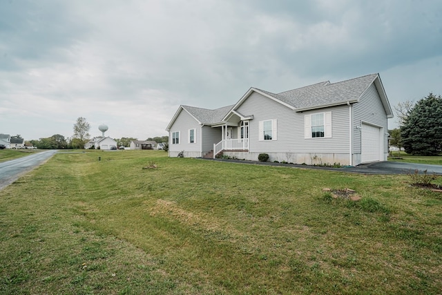 view of front of property featuring a porch, aphalt driveway, roof with shingles, a front lawn, and an attached garage