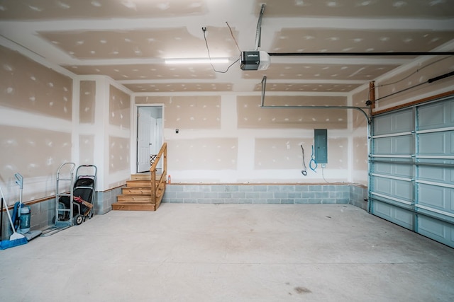 garage featuring a garage door opener and electric panel