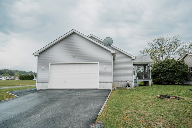 view of home's exterior featuring driveway, a yard, and an attached garage