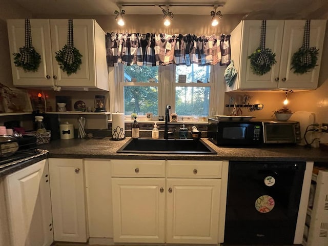 kitchen with black appliances, white cabinets, and sink