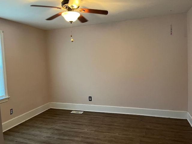 spare room featuring dark hardwood / wood-style floors and ceiling fan