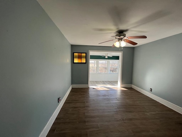 unfurnished room with ceiling fan and dark hardwood / wood-style flooring