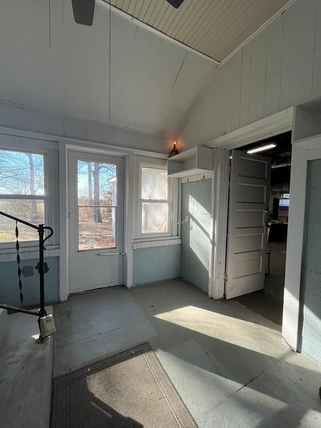 unfurnished sunroom featuring vaulted ceiling