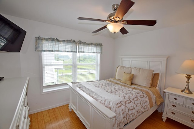 bedroom with ceiling fan and wood-type flooring