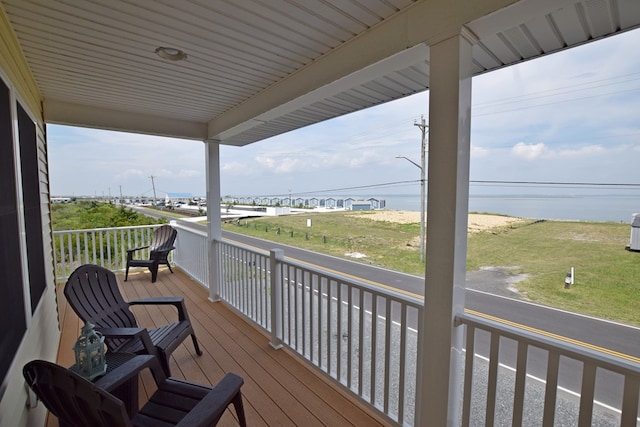 wooden deck featuring a water view