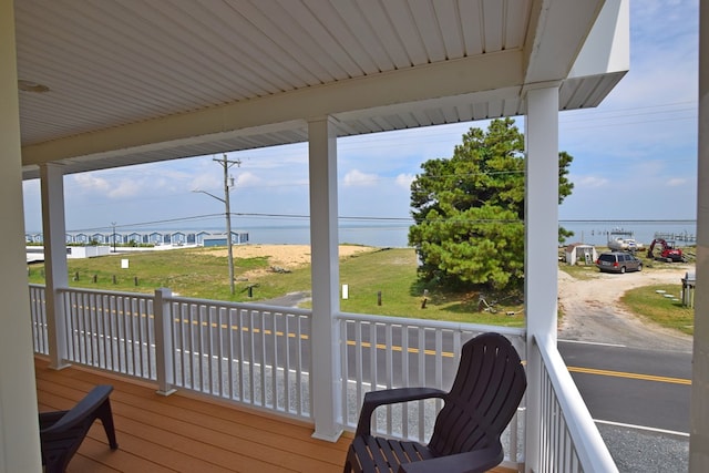 wooden terrace featuring a water view