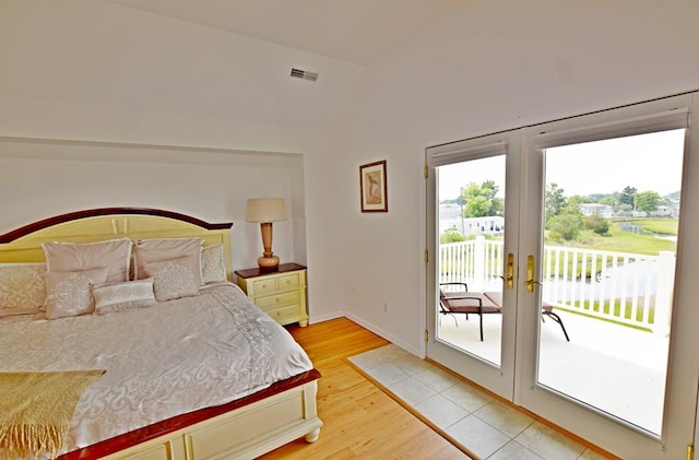 bedroom featuring wood-type flooring, access to outside, and french doors