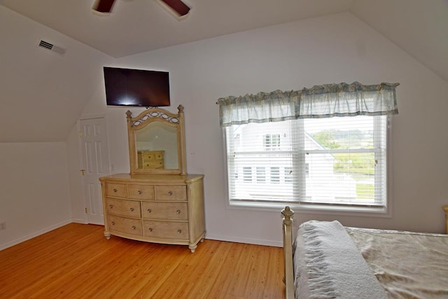 bedroom with ceiling fan, vaulted ceiling, and light hardwood / wood-style flooring