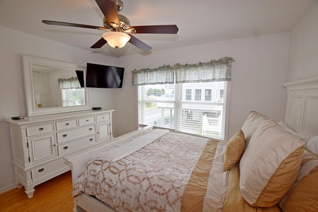 bedroom with light wood-type flooring and ceiling fan