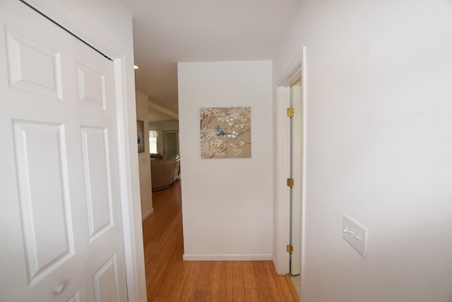 corridor with light hardwood / wood-style floors