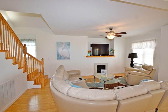 living room featuring ceiling fan and light hardwood / wood-style floors