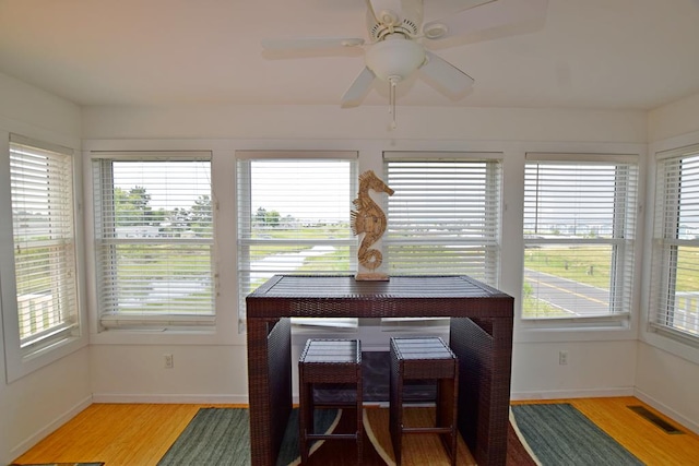 dining area with hardwood / wood-style flooring and ceiling fan