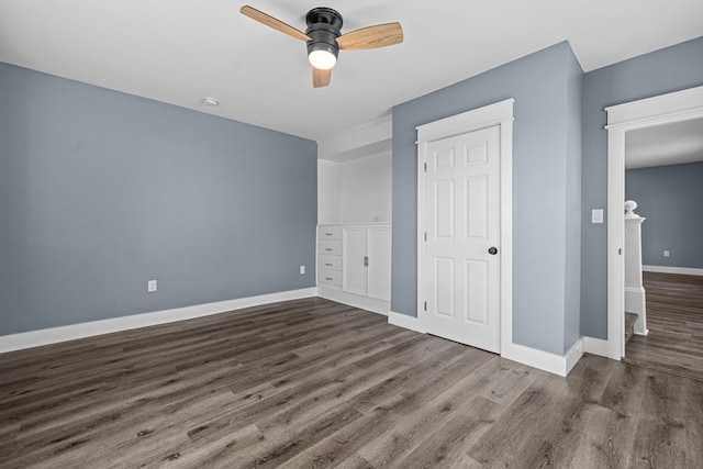 unfurnished bedroom featuring dark wood-type flooring and ceiling fan