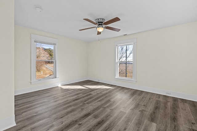 unfurnished room with dark wood-type flooring and ceiling fan