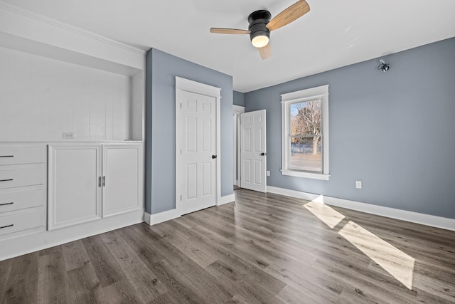 unfurnished bedroom featuring wood-type flooring and ceiling fan