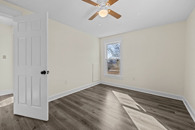 spare room with dark hardwood / wood-style floors and ceiling fan