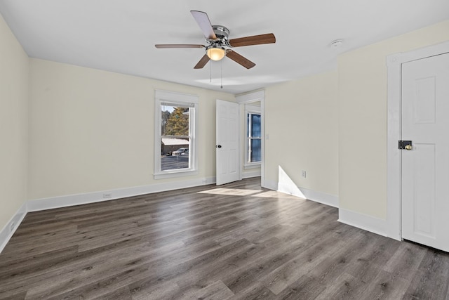 unfurnished room with dark hardwood / wood-style floors and ceiling fan