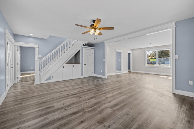 unfurnished living room with ceiling fan and wood-type flooring