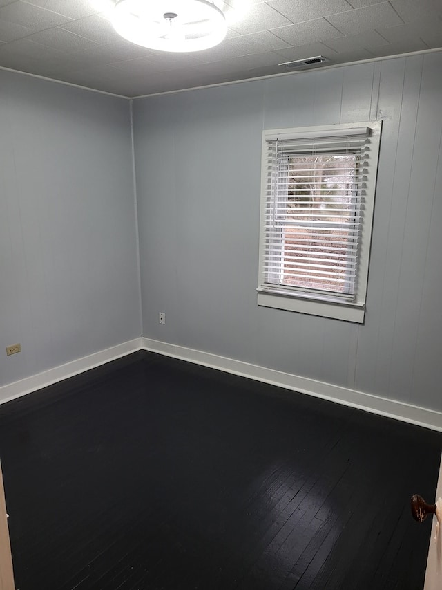 unfurnished room with wood-type flooring