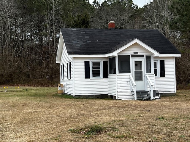 view of outbuilding featuring a yard