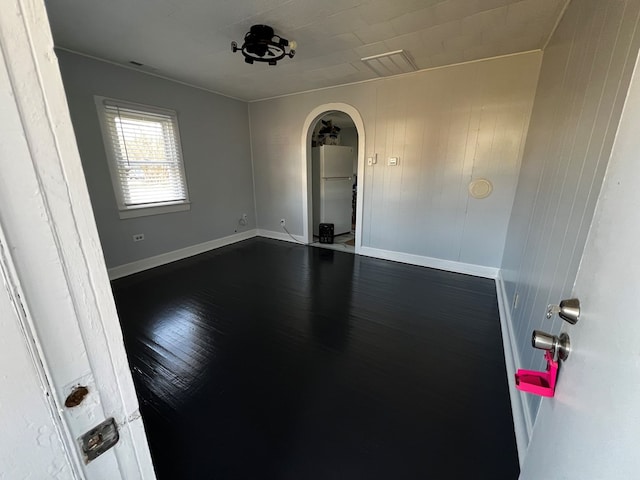 empty room with dark hardwood / wood-style floors