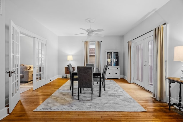 dining area featuring french doors, light wood-type flooring, and ceiling fan